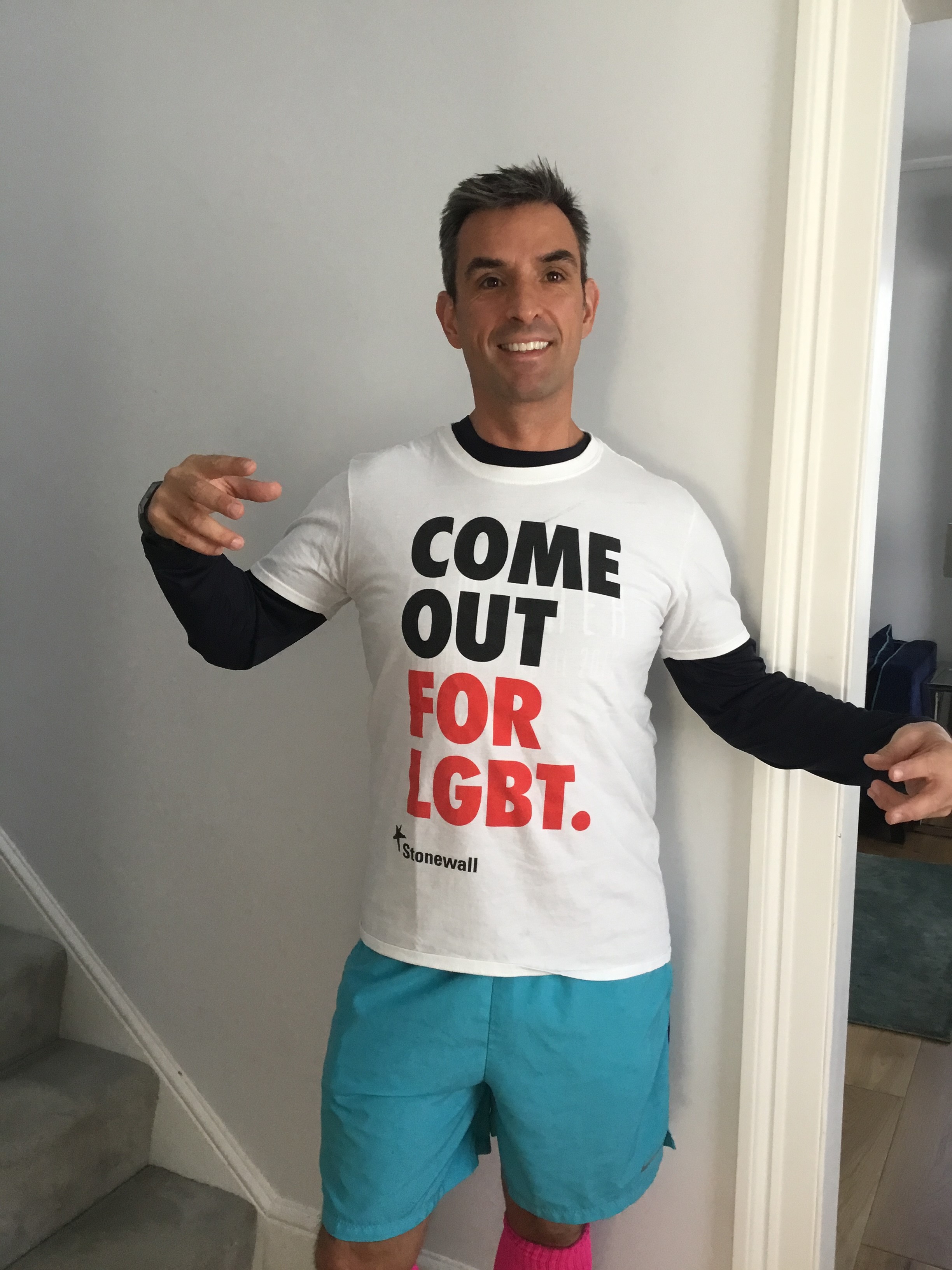 Simon Blake OBE wearing a Stonewall campaign t-shirt that reads 'come out for LGBT'