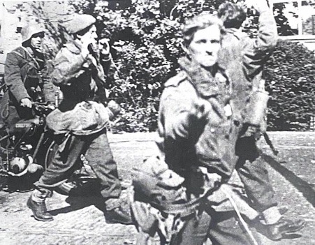 Image of my great-grandfather Ted (second on the left, with his hands in the air, not looking at the camera) found in the Battle of Arnhem, page 8, Pitkin Publishing 1998- as he was captured by the Germans (taking the photo)