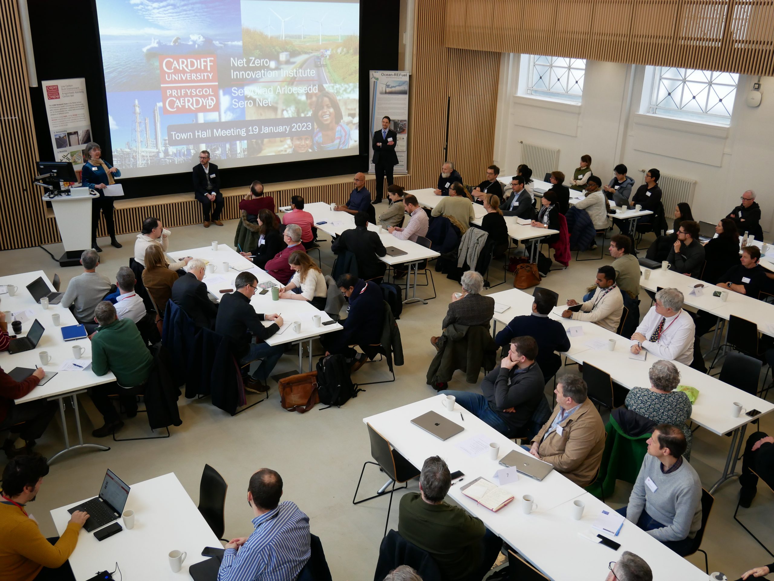 Photo shows a room of people attending a Net Zero Innovation Institute Town Hall event.