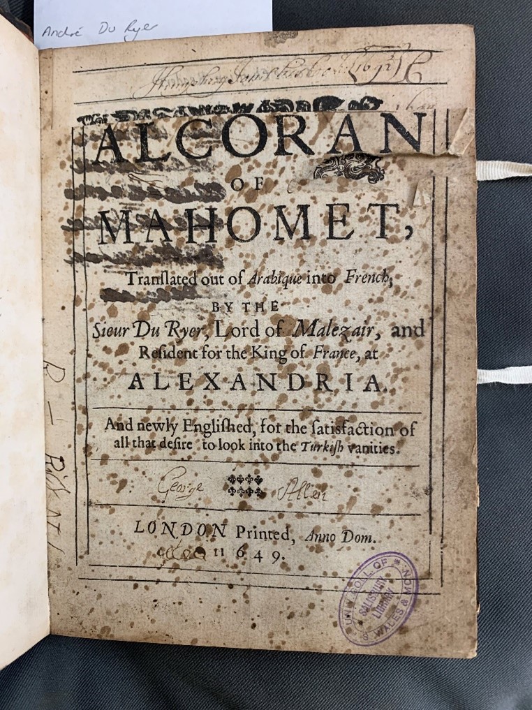 Picture of the opening page of an old Qur'an translation from Cardiff University's special collection. The page is quite yellowed and damaged, but through must the phrase 