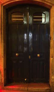 photo of doors to 42 rue Bonaparte, Paris at night