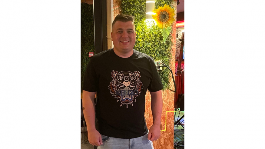 Person standing and smiling