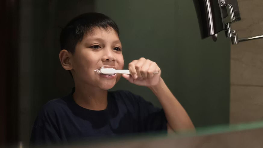 A boy brushing his teeth