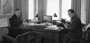 Image of two men working