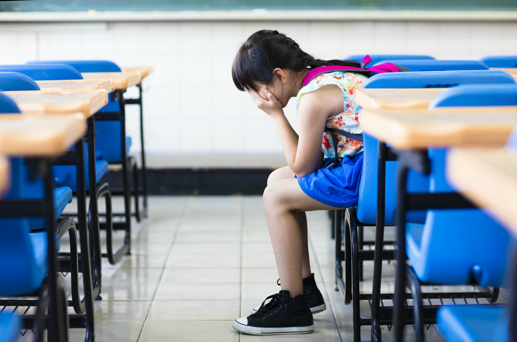 Girls may perform better at school than boys – but their experience is much less happy